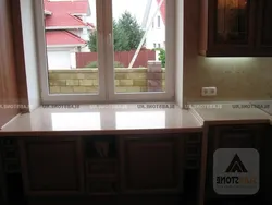 If the countertop is higher than the window sill in the kitchen photo