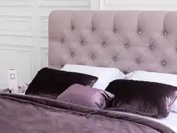 Photo of a bedroom with a fabric bed