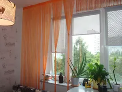 Photo of curtains for the kitchen if the wallpaper is orange