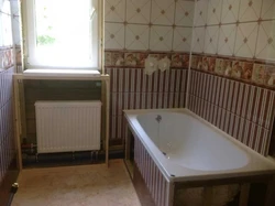 Finishing A Bathroom In A Wooden House With Plastic Panels Photo