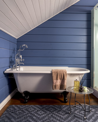 Finishing a bathroom in a wooden house with plastic panels photo