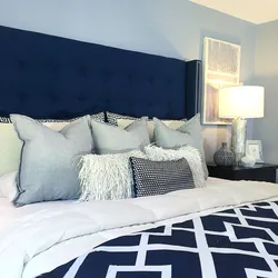 Soft blue bed in the bedroom interior