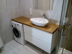 Photo of a bathroom cabinet with a washing machine