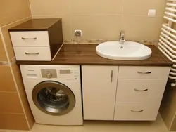 Photo of a bathroom cabinet with a washing machine