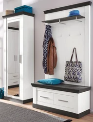 Narrow hallway with mirror and shoe rack photo