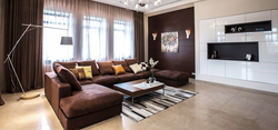 Brown curtains in the interior of a living room with a sofa