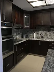 Gray kitchen with dark countertop and apron photo