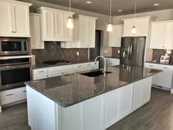 Gray kitchen with dark countertop and apron photo