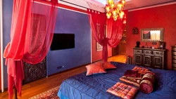 Red curtains in the bedroom interior