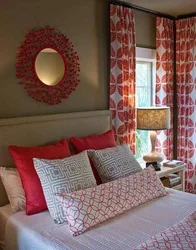 Red curtains in the bedroom interior