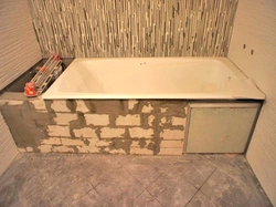 Do-it-yourself bathtub made of bricks and tiles photo