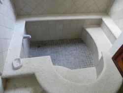 Do-it-yourself bathtub made of bricks and tiles photo