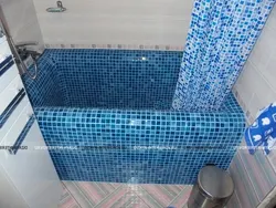 Do-it-yourself bathtub made of bricks and tiles photo