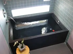 Do-it-yourself bathtub made of bricks and tiles photo