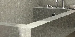 Do-it-yourself bathtub made of bricks and tiles photo