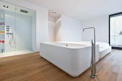 Bathtub with wooden floor photo