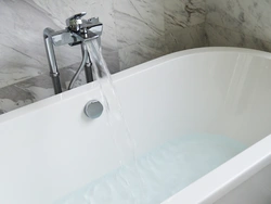 Photo of a bathtub with water in an apartment