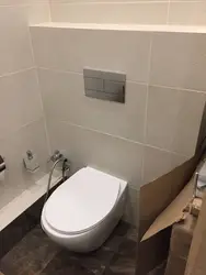 Bathtub with wall-hung toilet photo