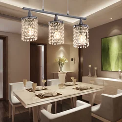 Chandelier in the living room above the table in the interior