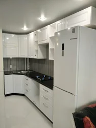 Photo of a kitchen with a white refrigerator