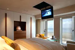 Bedroom design with tv by the window