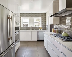 Kitchen covered in tiles up to the ceiling photo