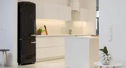 Black refrigerator in the kitchen interior