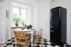 Black refrigerator in the kitchen interior