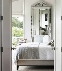 Mirrors opposite the bed in the bedroom photo
