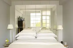 Mirrors opposite the bed in the bedroom photo