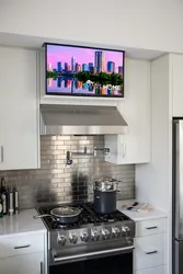 Photo of a small kitchen with a TV