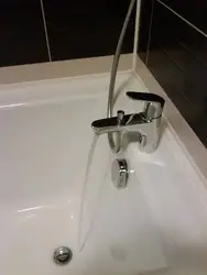 Photo of the bathtub where the faucets are on the bathtub