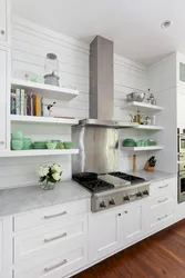 Photo of a corner kitchen with open shelves