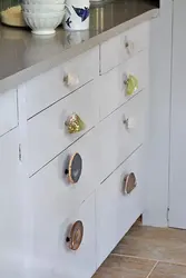Button handles in the kitchen in the interior