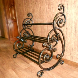 Forged shoe rack in the hallway photo