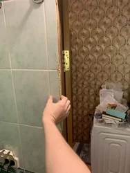 Photo of a bathroom door without trim