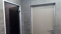 Photo of a bathroom door without trim