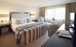 Bedroom design with bed and armchair