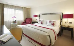 Bedroom design with bed and armchair