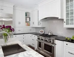 White kitchen in the interior with a dark apron
