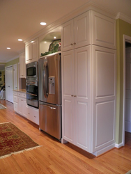 Refrigerator in a niche in the interior of the kitchen