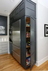 Refrigerator in a niche in the interior of the kitchen