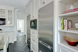 Refrigerator in a niche in the interior of the kitchen