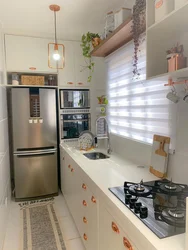 Narrow refrigerator in a small kitchen photo