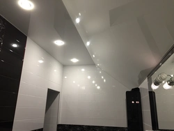 Photo of glossy stretch ceilings in the bathroom