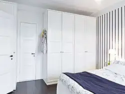 White wardrobe in the bedroom in the interior photo