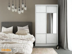 White wardrobe in the bedroom in the interior photo