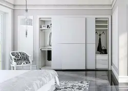 White wardrobe in the bedroom in the interior photo