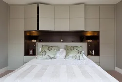 Wardrobe around the bed in the bedroom design