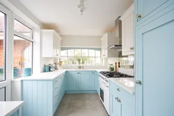 White kitchen with blue walls photo